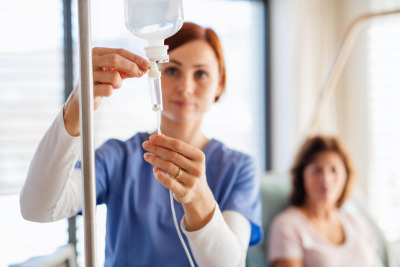 Nurse prepping infusion therapy for patient